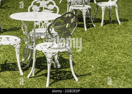 white nice tables and chairs on a green meadow on a wedding in a garden in the summer Stock Photo