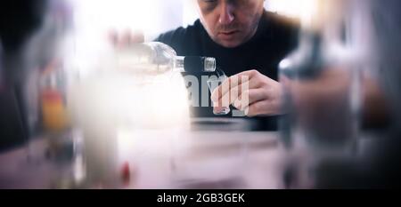 man addicted to alcohol drinks vodka alone Stock Photo