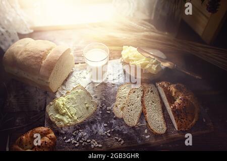 Delicious breakfast on a sunny morning with milk and bread with butter Stock Photo