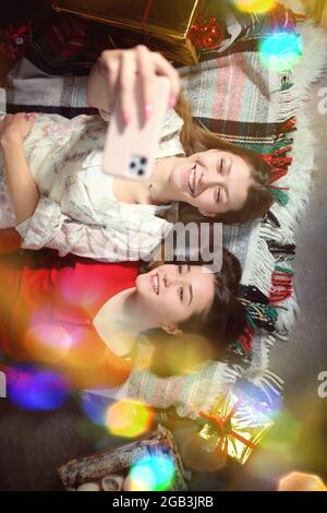 young friends are taking a selfie at a pajama party Stock Photo