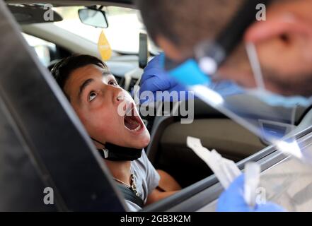 (210802) -- BEIJING, Aug. 2, 2021 (Xinhua) -- An Israeli child receives a COVID-19 test at a drive-through complex in central Israeli city of Beit Shemesh on July 18, 2021. (Xinhua/Gil Cohen Magen)