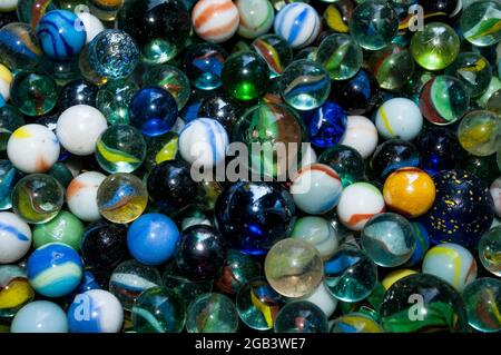 Colorful glass marbles of different sizes in a color pattern Stock Photo