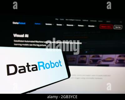 Cellphone with logo of American augmented intelligence company DataRobot Inc. on screen in front of website. Focus on center-left of phone display. Stock Photo