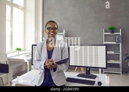 Portrait of a professional african american female manager near her workplace in a modern office. Stock Photo