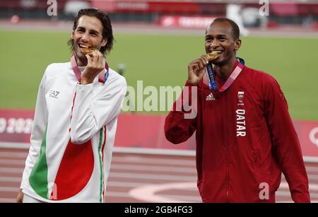 Tokyo, Japan. 02nd Aug, 2021. Gold medalists Mutaz Essa Barshim of Qatar (L) and Gianmarco Tamberi of Italy (R), stand on the podium at the awards ceremony for the Men's High Jump at the Athletics competition at Olympic Stadium during the 2020 Summer Olympics in Tokyo, Japan on Monday, August 2, 2021. Barshim and Tamberi ended in a tie and the Gold medal was awarded to both. Photo by Tasos Katopodis/UPI Credit: UPI/Alamy Live News Stock Photo