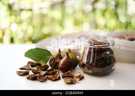 Fresh figs lie on the table next to dried figs Stock Photo