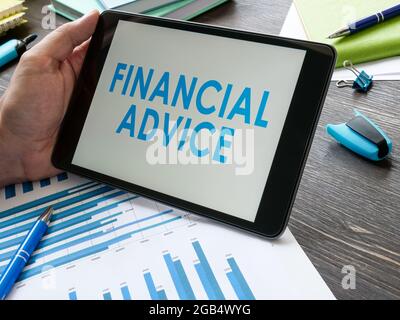 Man reads financial advice on the tablet. Stock Photo
