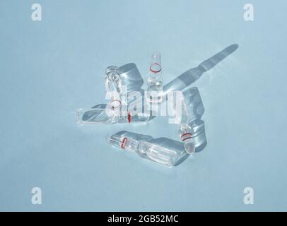Glass ampoules with medicinal product, vaccine for medical and cosmetic injections Composition from ampoules with shadows Stock Photo