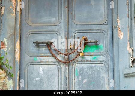 An old door that was chained and locked. an inaccessible old building. security concept Stock Photo
