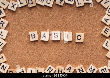 BASIC word written on wood block. BASIC text on wooden table. Business Concept Stock Photo