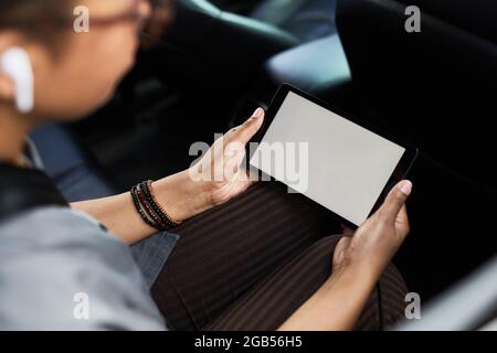 Close-up of woman sitting in the car and watching video online using mobile phone Stock Photo