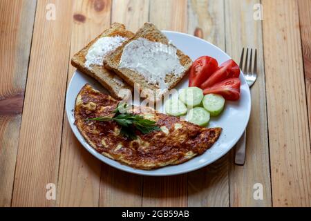 Cheese omelet with toasts at home kitchen on wooden table. Food photography Stock Photo