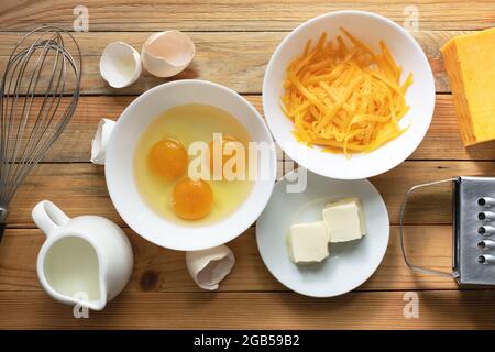 Ingredients for cheese omelet preparation on wooden table. Food photography Stock Photo
