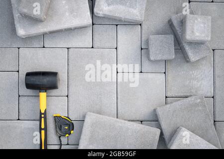 Paving stones paving background. Installing tools on foreground Stock Photo