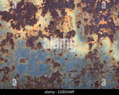 Heavily ruined metal surface textured with big rust spots background Stock Photo