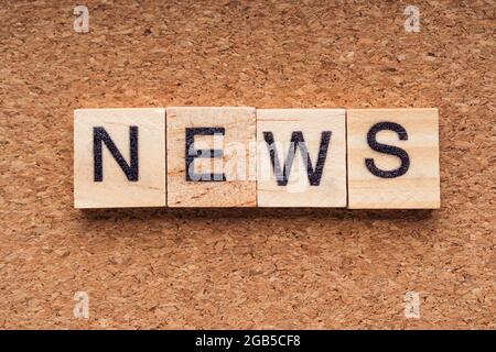 NEWS word written on wood block. NEWS text on wooden table. Business Concept Stock Photo