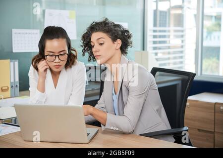 Diverse business team working on project together and discussing marketing strategy Stock Photo