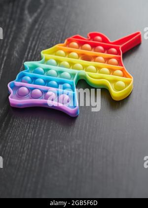 Antistress popit colorful silicone toy  on wooden table background Stock Photo