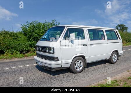 2000 white VW Volkswagen Microbus 26i 2553cc petrol people carrier en-route to Capesthorne Hall classic July car show, Cheshire, UK Stock Photo