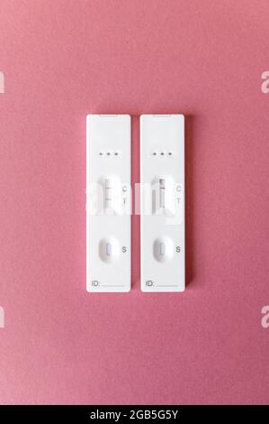 Positive and negative rapid lateral flow COVID 19 tests Stock Photo