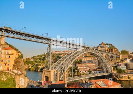 Portugal, Porto, October 06,2019 Tram cars and people passing over Dom Luis I Bridge with a scenic view on the historic center of Porto, Portugal Stock Photo