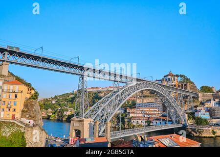 Portugal, Porto, October 06,2019 Tram cars and people passing over Dom Luis I Bridge with a scenic view on the historic center of Porto, Portugal Stock Photo