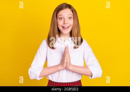 Photo of cute blond teen girl ask wear white shirt isolated on yellow color background Stock Photo