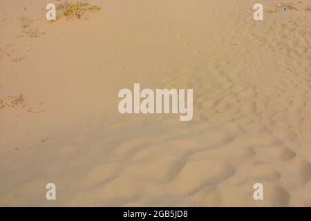 Abstract background of wavy sand dunes. Pattern on the sands. Beach background. Pattern of the beach with wavy surface. Desert, beach, vacation, holid Stock Photo