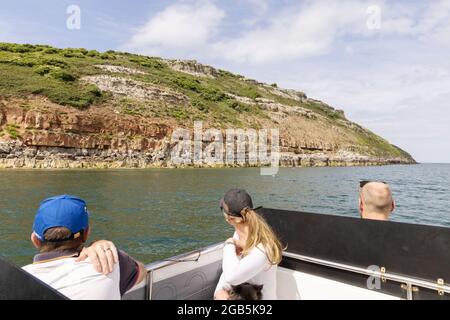 Puffin island anglesey Wales; tourists on a boat trip to Puffin Island off the coast of Anglesey, Wales UK Stock Photo