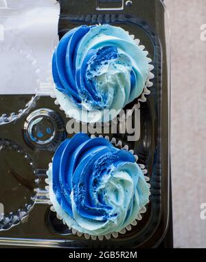 A High Angle View of Chocolate Cupcakes With Blue Icing Stock Photo
