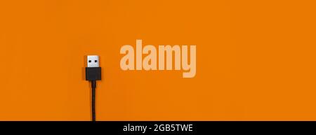 panorama of USB wires on orange background Stock Photo