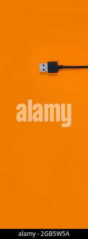 panorama of USB wires on orange background Stock Photo