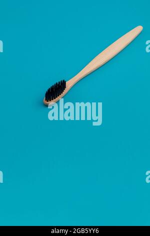 Wooden toothbrush on blue background Stock Photo