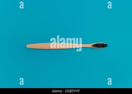Wooden toothbrush on blue background Stock Photo