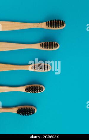 Wooden toothbrush on blue background Stock Photo