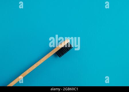 Wooden toothbrush on blue background Stock Photo