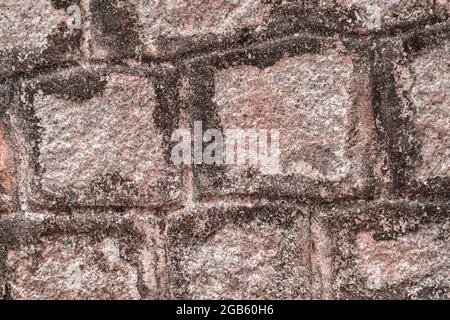 Old Temple wall. Rectangular cut out marble granite brick real surface stone with cement. Pattern pink color rustic texture background. Design website Stock Photo