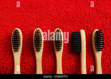 toothbrush with red and yellow towel on blue background Stock Photo
