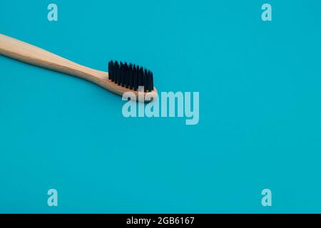 Wooden toothbrush on blue background Stock Photo