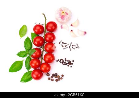 Top view of red ​​tomato cherry with green basil leaves and young garlic, spice, isolated on white background, Flat lay. Stock Photo