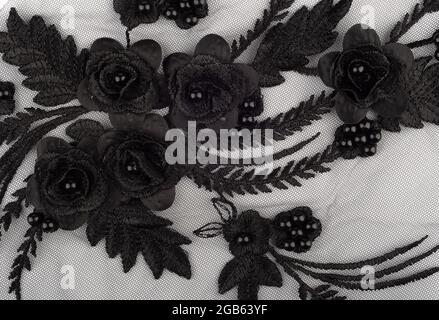 Handmade floral black applique on transparent fabric. Top view.. Stock Photo