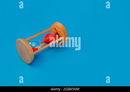 hourglass on blue on blue background Stock Photo