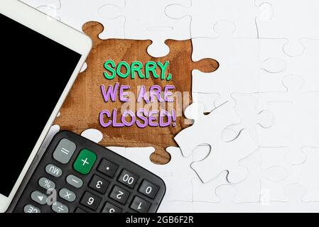 Sign displaying Sorry, We Are Closed. Concept meaning apologize for shutting off business for specific time Building An Unfinished White Jigsaw Stock Photo