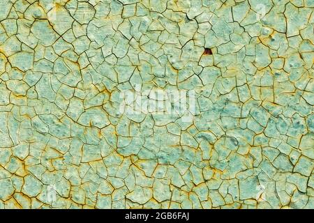 Cracked turquoise paint texture. Old crackled teal turquoise painted wood surface. Green turquoise painted cracked wall texture Stock Photo