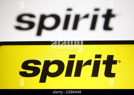 In this photo illustration, Spirit Airlines logo of the US airline seen on a smartphone and a pc screen. (Credit Image: © Pavlo Gonchar/SOPA Images via ZUMA Press Wire) Stock Photo
