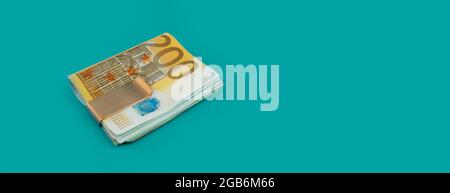 Money clip with euro bills on blue background Stock Photo