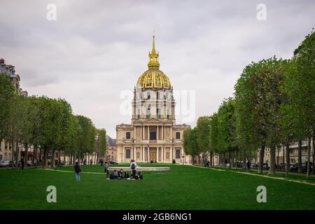 Paris, France, Feb 2020, young people on a lawn in front of the dome of the Invalides in the 7th district of the capital Stock Photo