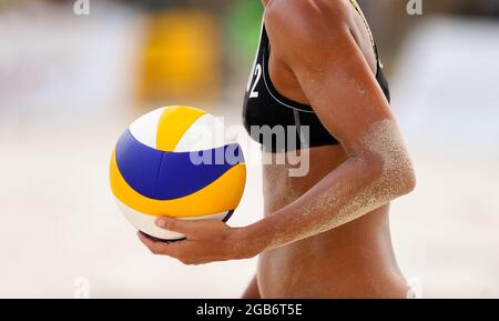 A Female Beach Volleyball Player Is Getting Ready To Serve The Ball Stock Photo