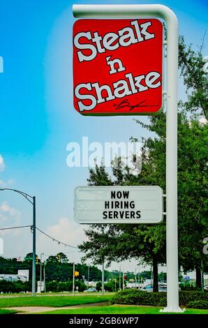 Steak ’n Shake restaurant displays a “now hiring sign” on Highway 90, Aug. 1, 2021, in Mobile, Alabama. Steak ’n Shake was founded in 1934 in Illinois. Stock Photo