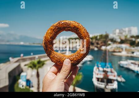 Turkish bread simit. Traditional baked bagel in Turkey sold as street food and eaten with tea for breakfast or lunch. High quality photo Stock Photo